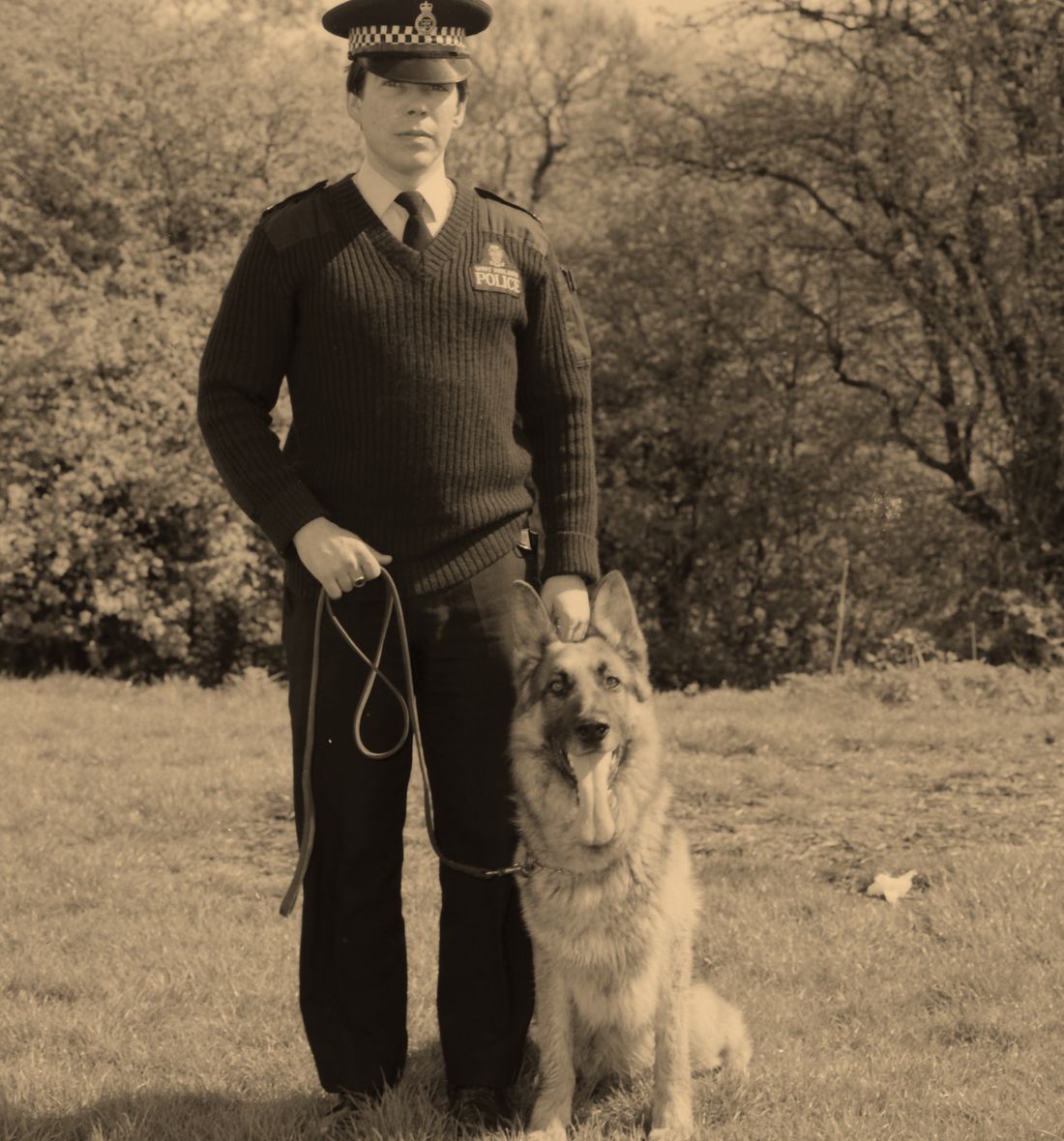 Uniformed security officer with a trained patrol dog